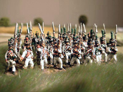 Italian troops moving through wild grass.